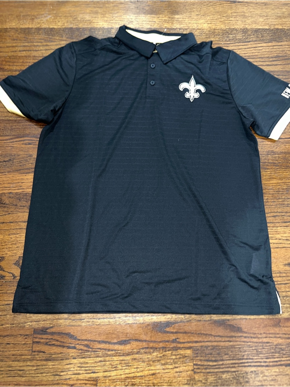 New Orleans Saints polo shirt featuring the team's signature fleur-de-lis logo